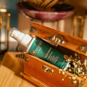 Serenade HappyFace Face Wash with Orange, Neroli, Cypress and Lavender essential oils placed in a wooden box for aromatherapy skincare and glowing skin routine